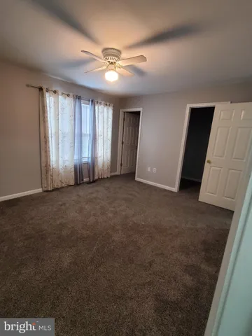 a bathroom with a sink a toilet and shower curtain