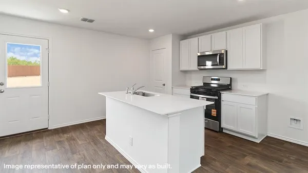 a utility room with cabinets washer and dryer