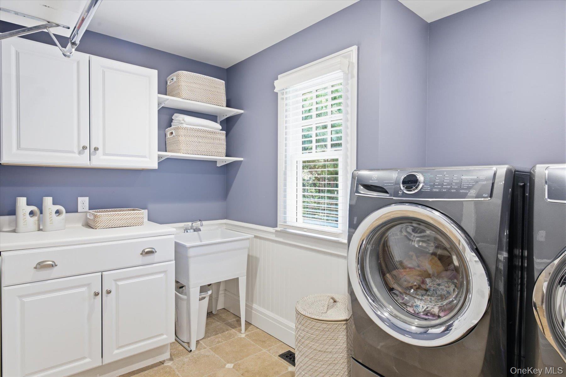 134 Sandy Hollow Road Northport, NY 11768 - Photo 20 of 28 Well-designed laundry room with custom cabinetry and utility sink.