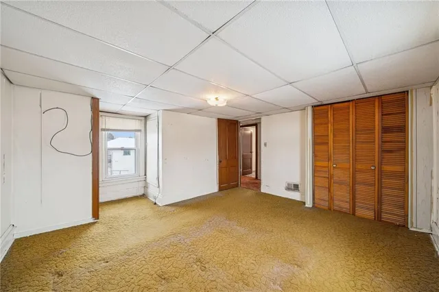 a view of an empty room with closet area