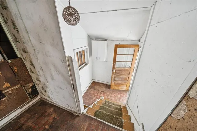 a view of a hallway with wooden cabinets and entryway