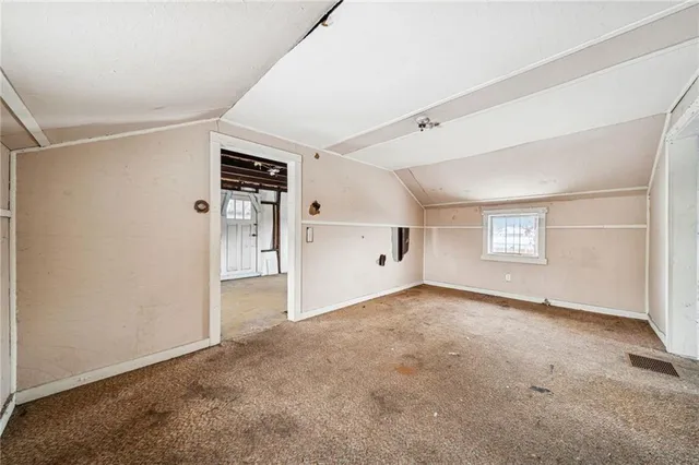 a view of a white house with a large tree covered with snow in front of house