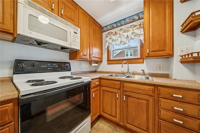 a kitchen with stainless steel appliances granite countertop a stove and a sink