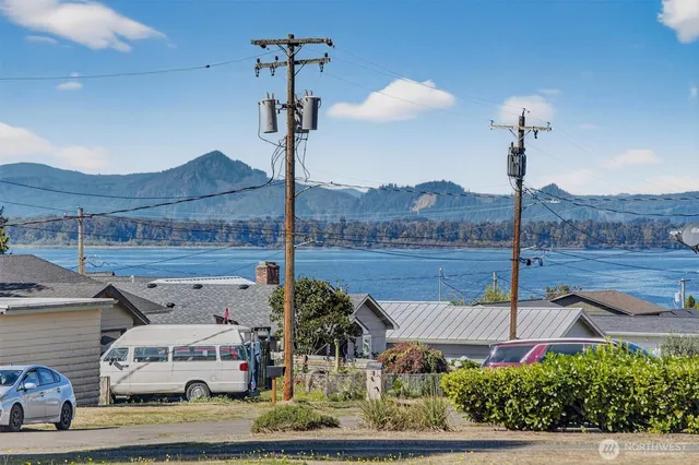 a view of a street with an house and car parked