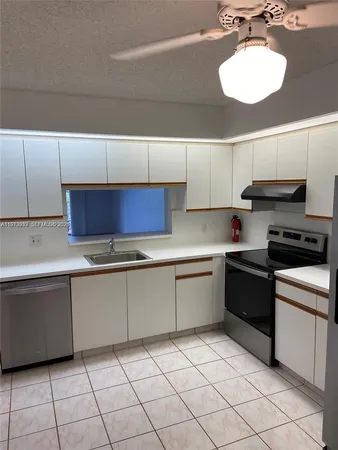 a kitchen with a sink cabinets and appliances