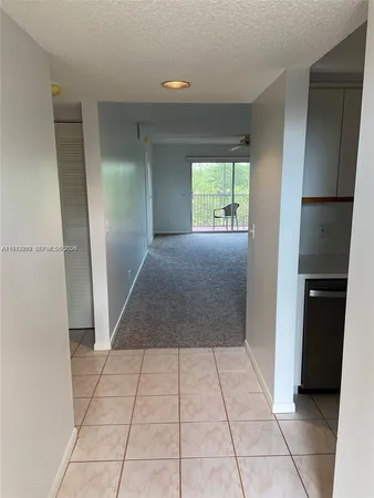 a view of entryway with a window and a refrigerator