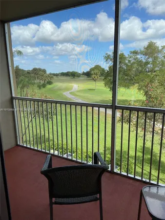 a view of a balcony with furniture and a garden