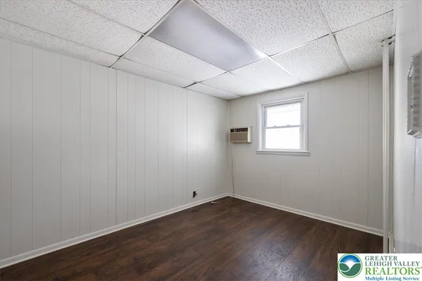 a view of a room with wooden floor and windows