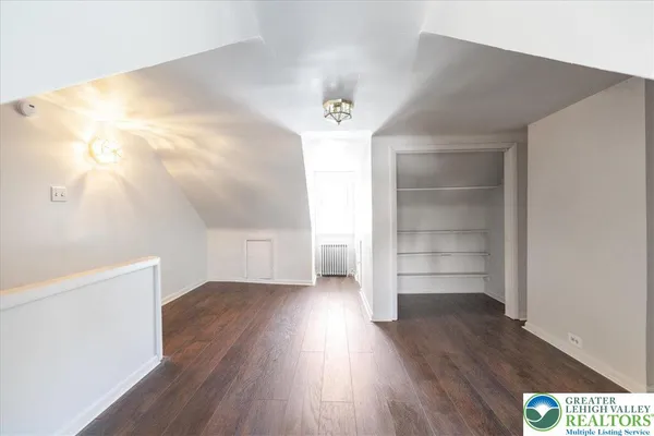 a view of empty room with wooden floor