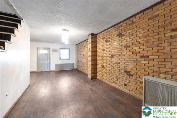 a view of wooden floor and windows in a room