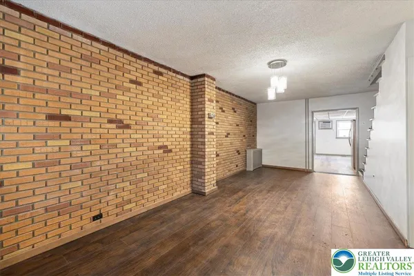 a view of an empty room and wooden floor