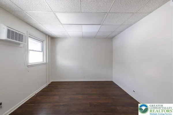 a view of a room with wooden floor and fan