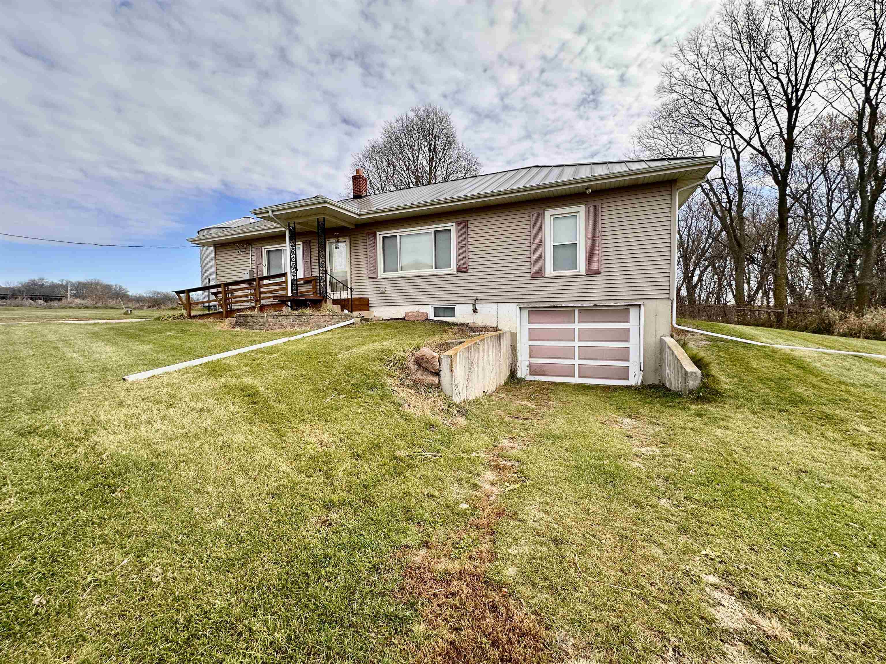 733 North Rock City Road Ridott, IL 61067 - Photo 3 of 35 a front view of a house with a garden and deck