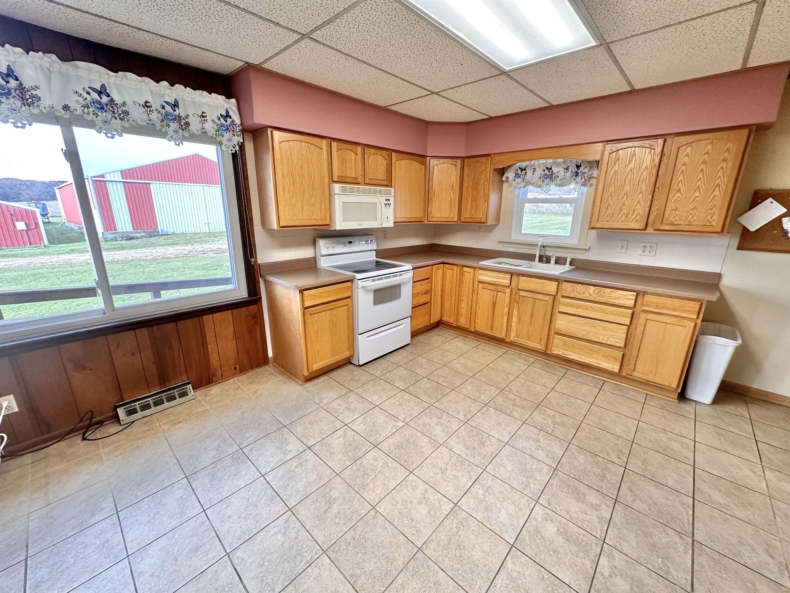 733 North Rock City Road Ridott, IL 61067 - Photo 9 of 35 a large kitchen with stainless steel appliances kitchen island granite countertop a large window