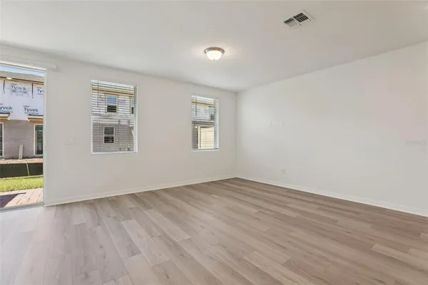 a view of a kitchen with wooden floor and stairs