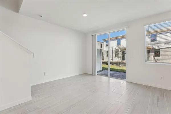 a large kitchen with stainless steel appliances a sink a stove a refrigerator and cabinets