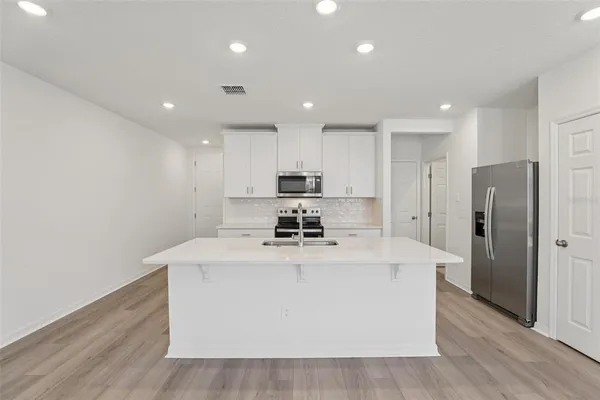 a kitchen with sink and mirror