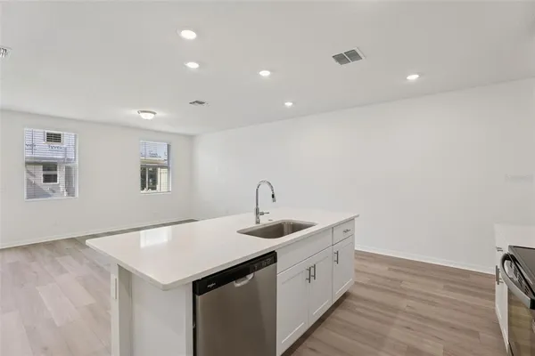 a bathroom with a granite countertop sink a toilet and shower