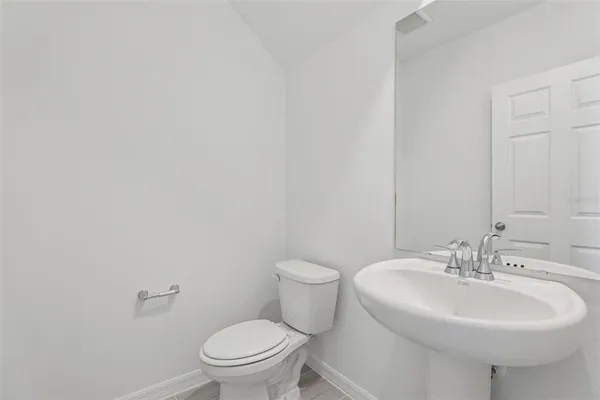 a bathroom with a double vanity sink mirror and toilet