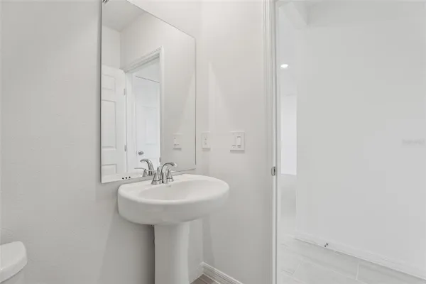 a spacious bathroom with a double vanity sink a mirror and a shower