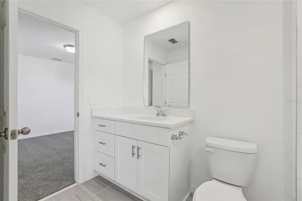 a bathroom with double vanity sink and a mirror