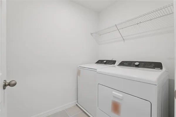 a view of a house with backyard and a tree