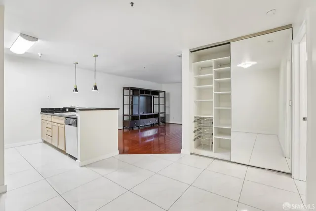 a kitchen with granite countertop a refrigerator and a stove top oven