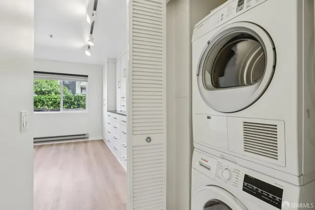 a view of a hallway with washer and dryer