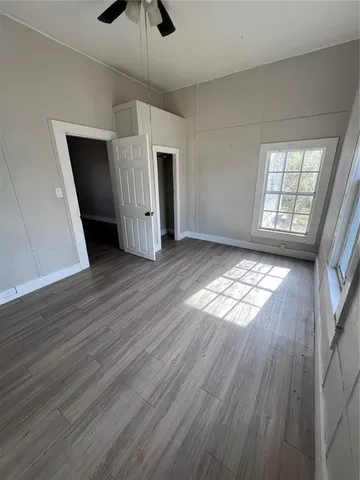 wooden floor in an empty room with a window