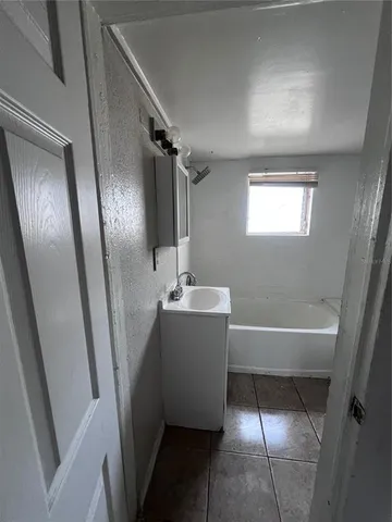 a bathroom with a bathtub and a sink