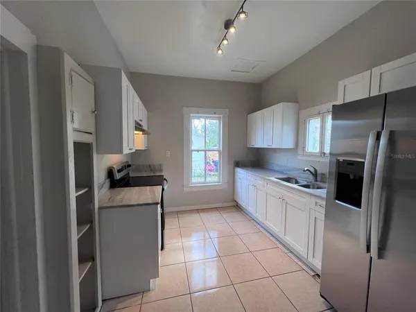 a kitchen with a refrigerator a sink and a stove
