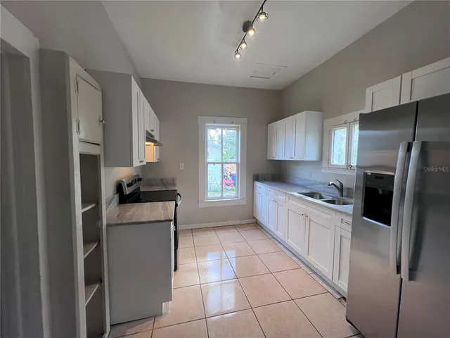 a kitchen with a refrigerator a sink and a stove