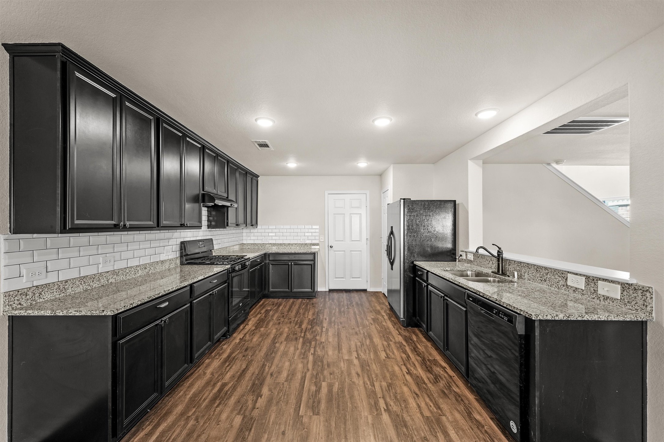 5710 Pampus Prairie Road Katy, TX 77493 - Photo 11 of 27 a large kitchen with a center island and stainless steel appliances