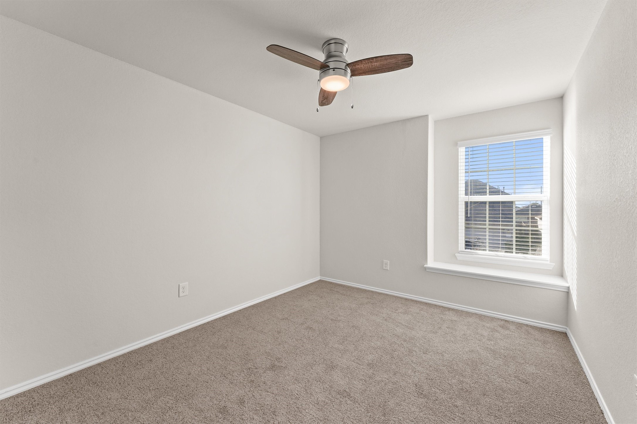 5710 Pampus Prairie Road Katy, TX 77493 - Photo 13 of 27 an empty room with a ceiling fan and windows
