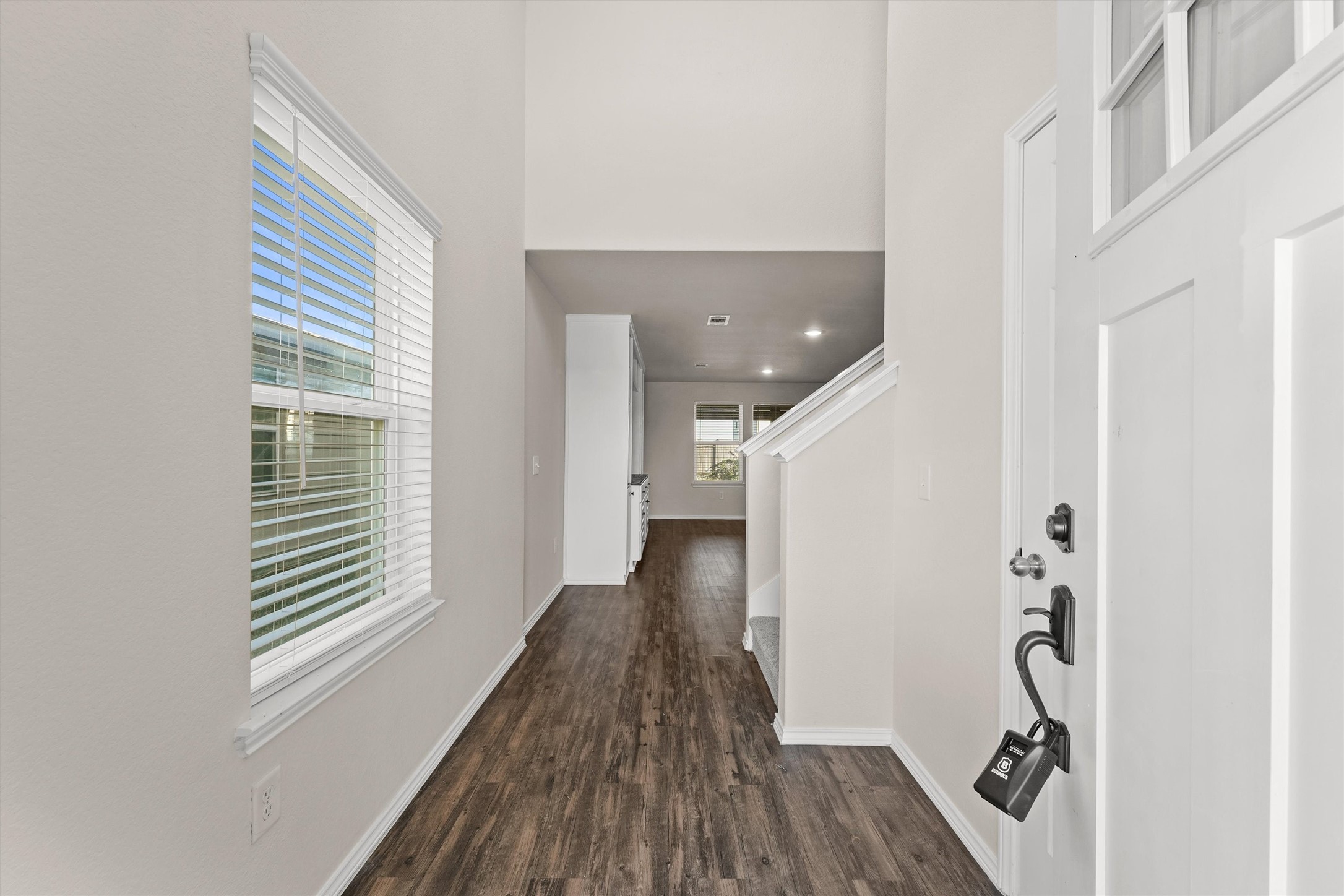 5710 Pampus Prairie Road Katy, TX 77493 - Photo 4 of 27 a view of a hallway with wooden floor and staircase