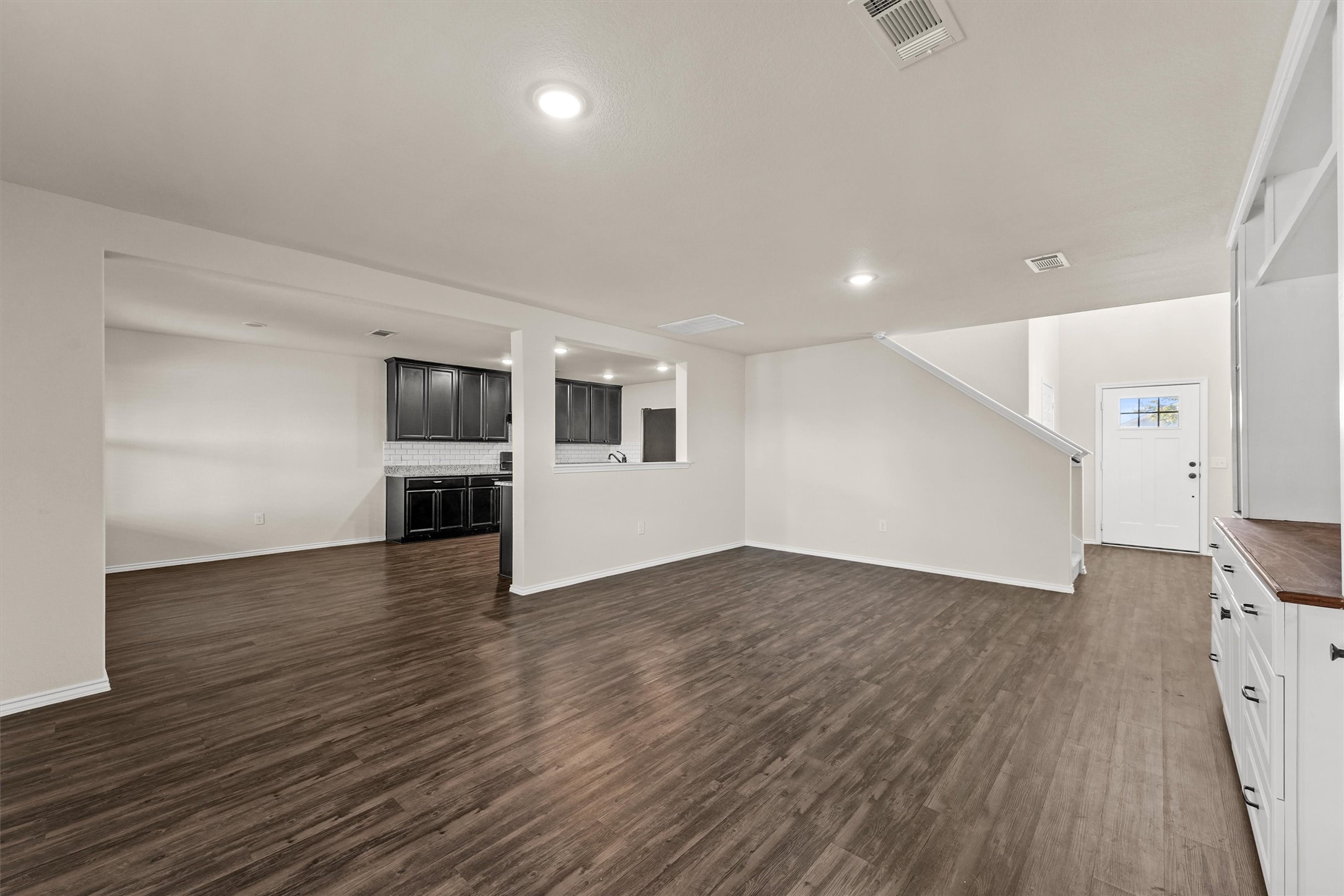 5710 Pampus Prairie Road Katy, TX 77493 - Photo 7 of 27 an empty room with wooden floor and windows