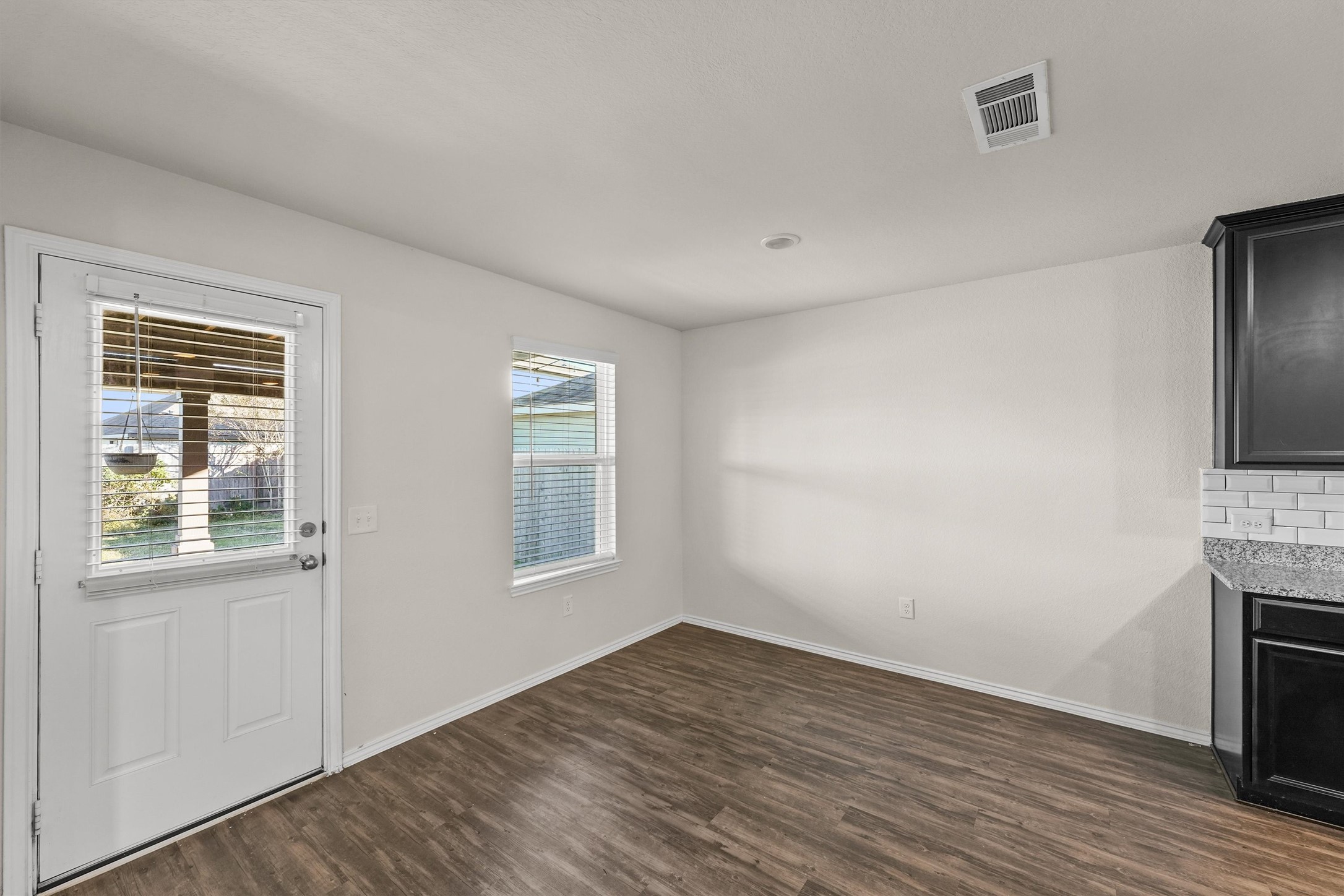 5710 Pampus Prairie Road Katy, TX 77493 - Photo 8 of 27 an empty room with a fireplace and wooden floor