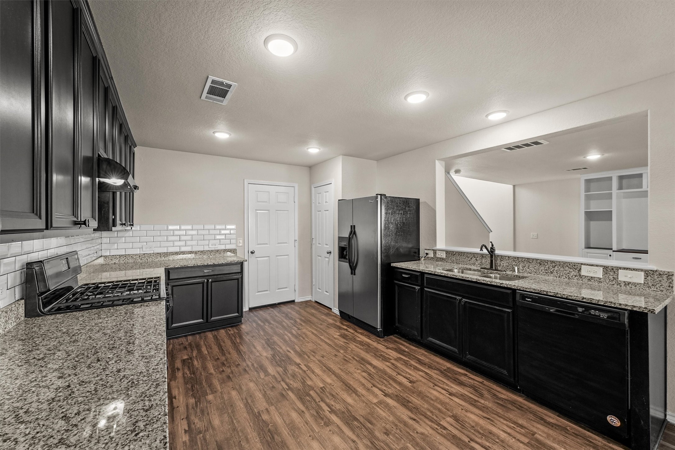 5710 Pampus Prairie Road Katy, TX 77493 - Photo 9 of 27 a large kitchen with stainless steel appliances granite countertop a stove a sink dishwasher a refrigerator and wooden cabinets