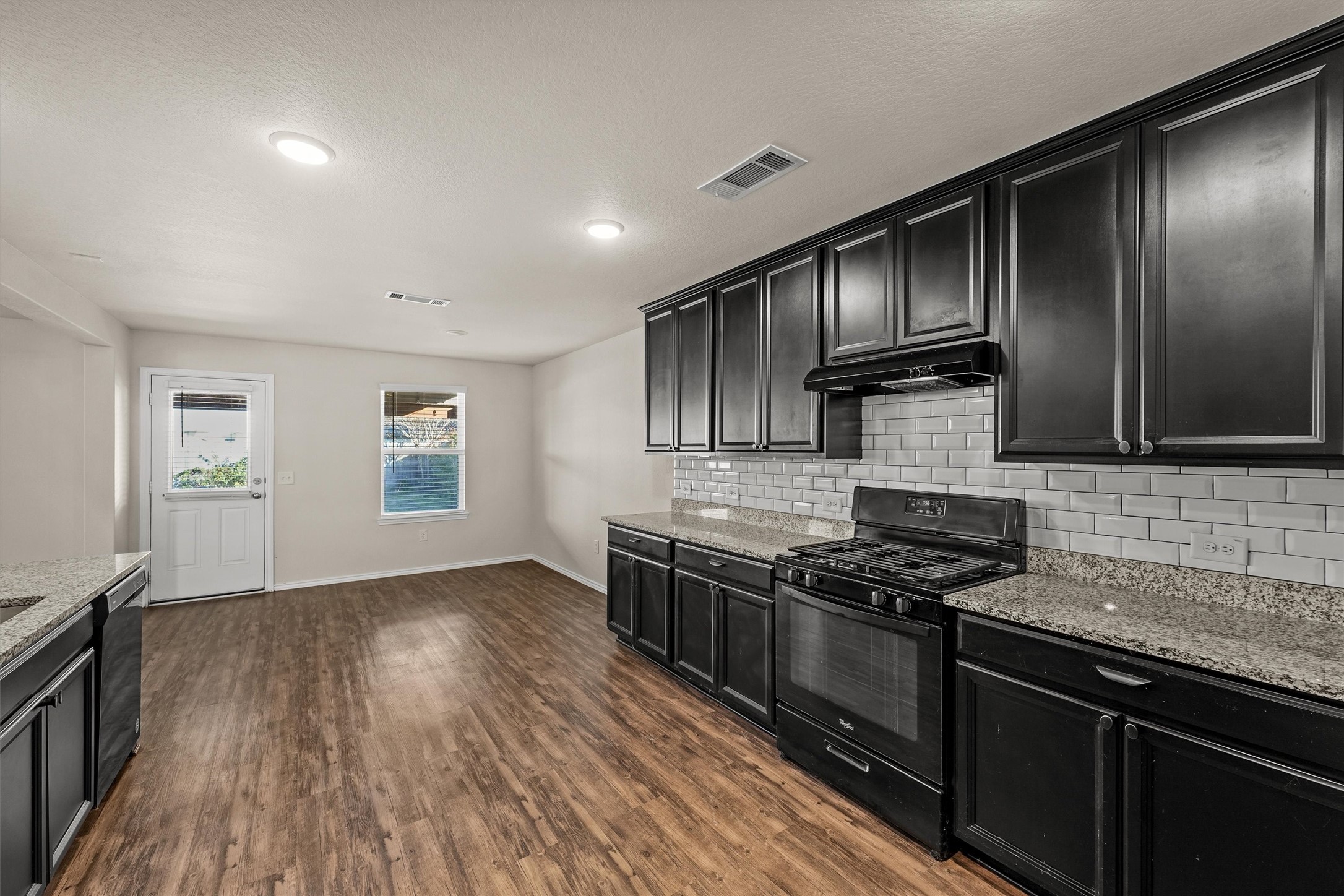 5710 Pampus Prairie Road Katy, TX 77493 - Photo 10 of 27 a kitchen with granite countertop stainless steel appliances and wooden cabinets