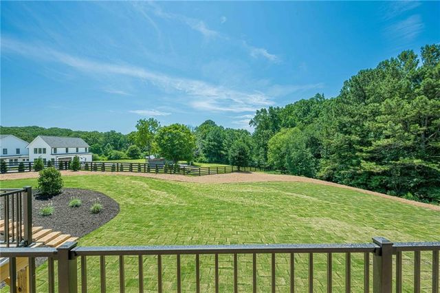 a spacious bathroom with a double vanity sink a large mirror and a bathtub