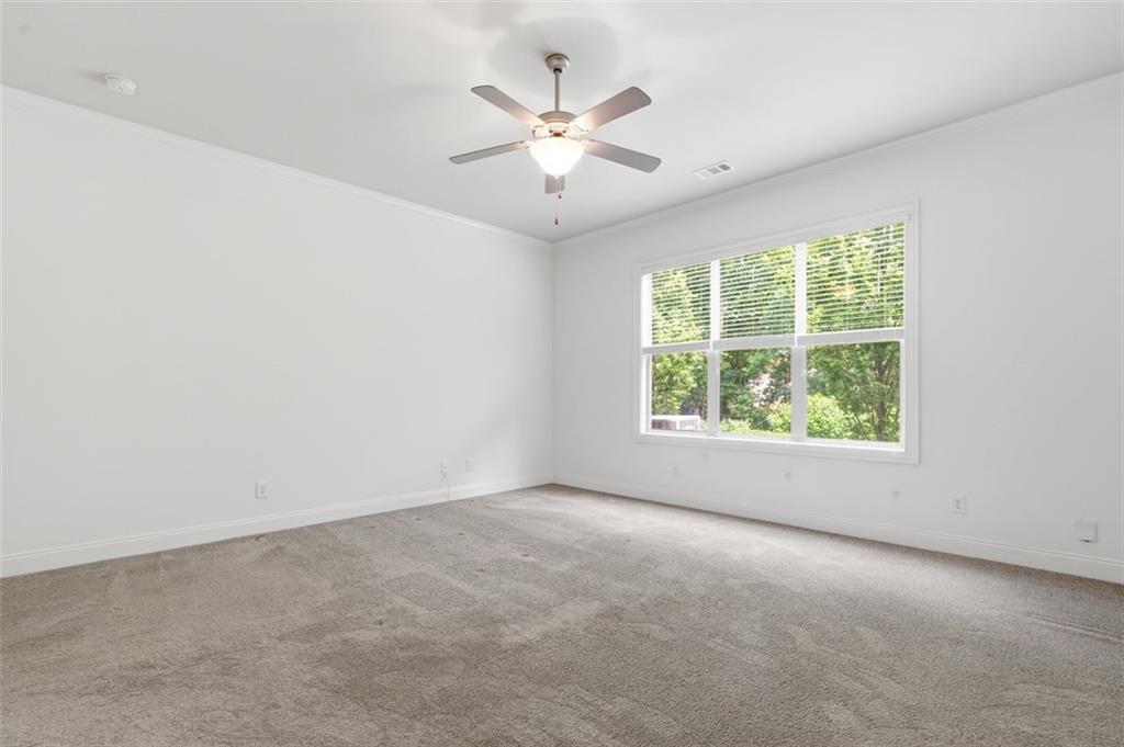 337 Rosshandler Road Suwanee, GA 30024 - Photo 34 of 45 an empty room with a window and a ceiling fan