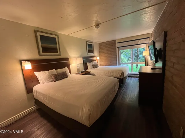 a bedroom with bed and window