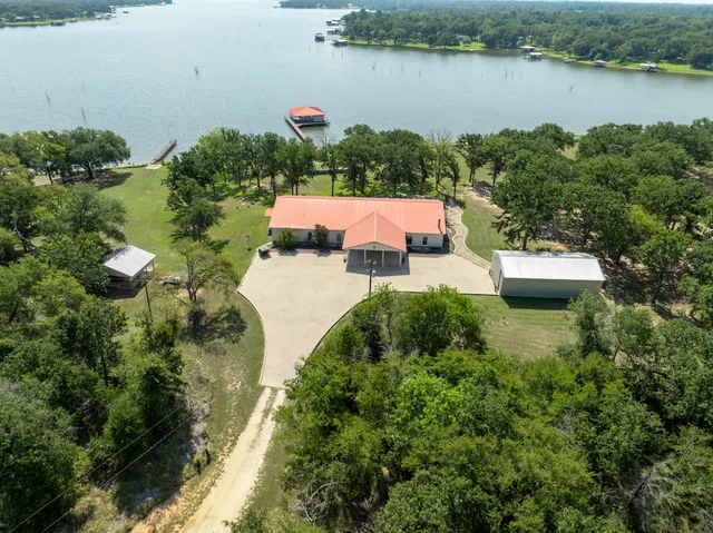 an aerial view of a house with a lake view