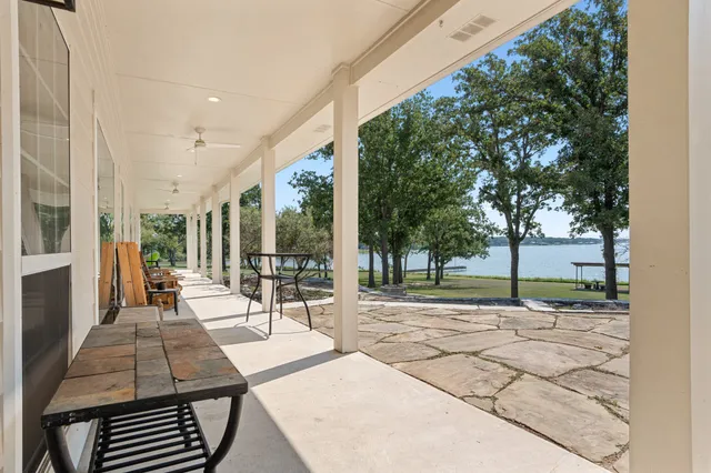 a backyard of a house with barbeque oven table and chairs