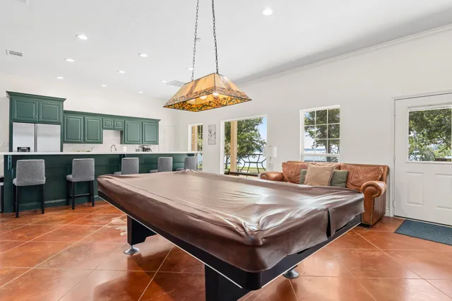 a kitchen with kitchen island a sink stainless steel appliances and cabinets