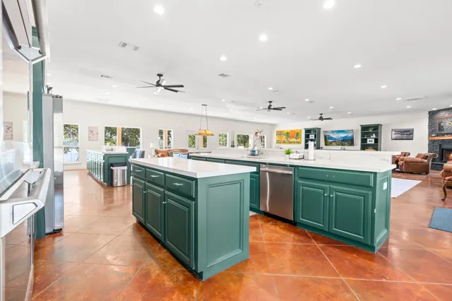 a kitchen with a sink dishwasher and a stove with wooden floor