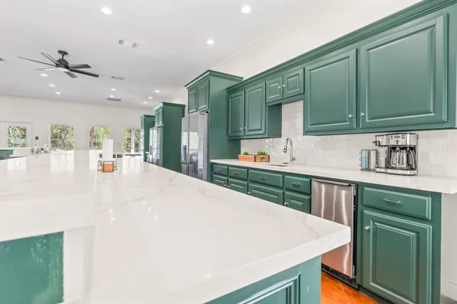 a bedroom with two beds and a large window