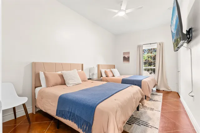 a bedroom with a bed and a flat screen tv