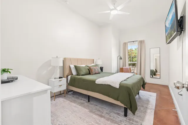 a bedroom with a bed and a window