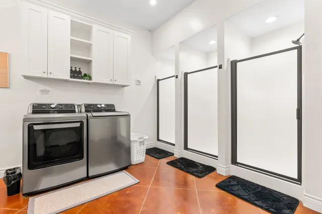 a bathroom with a glass shower door and a sink